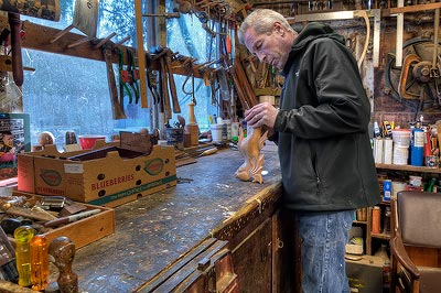 Tom Kieninger shaping a cabriole leg at the workbench.